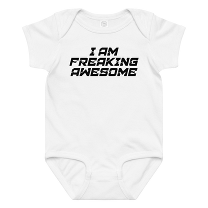 "I Am Freaking Awesome" printed on a white baby jersey bodysuit laying on a flat surface amongst other clothes