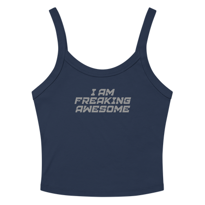 "I Am Freaking Awesome" printed on a solid navy blend women's micro-rib tanktop laying on a flat surface amongst sunglasses and shorts