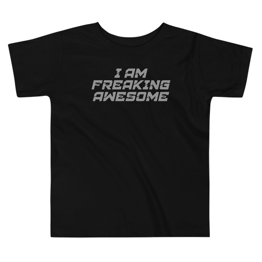 "I Am Freaking Awesome" printed on a black toddler short sleeve tee laying on a flat surface