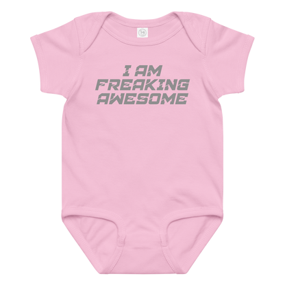 "I Am Freaking Awesome" printed on a pink baby jersey bodysuit laying on a flat surface amongst other clothes