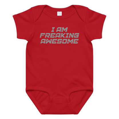 "I Am Freaking Awesome" printed on a red baby jersey bodysuit laying on a flat surface amongst other clothes