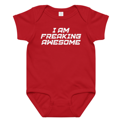 "I Am Freaking Awesome" printed on a red baby jersey bodysuit laying on a flat surface amongst other clothes