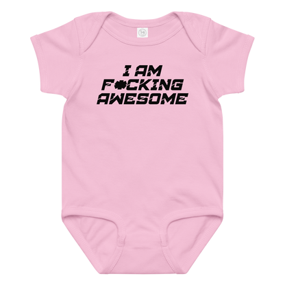 "I Am F*cking Awesome" printed on a pink baby jersey bodysuit laying on a flat surface amongst other clothes