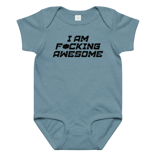 "I Am F*cking Awesome" printed on a vintage indigo baby jersey bodysuit laying on a flat surface amongst other clothes