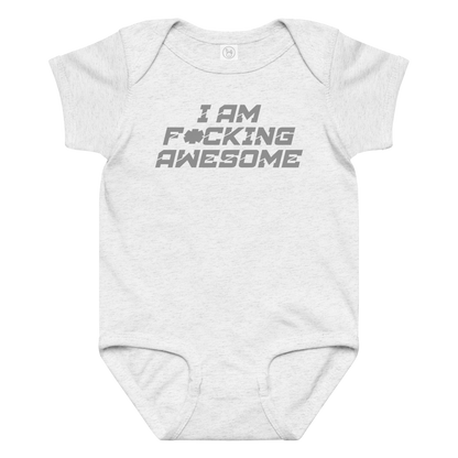 "I Am F*cking Awesome" printed on a ash baby jersey bodysuit laying on a flat surface amongst other clothes