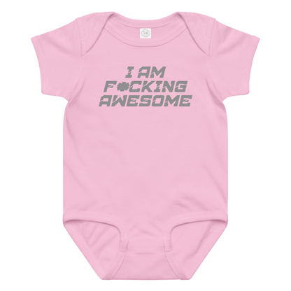 "I Am F*cking Awesome" printed on a pink baby jersey bodysuit laying on a flat surface amongst other clothes
