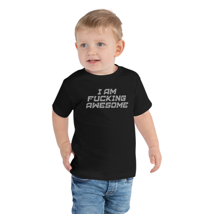 "I Am Fucking Awesome" printed on a black toddler short sleeve tee worn by a male