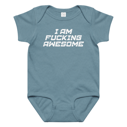"I Am Fucking Awesome" printed on a vintage indigo baby jersey bodysuit laying on a flat surface amongst other clothes