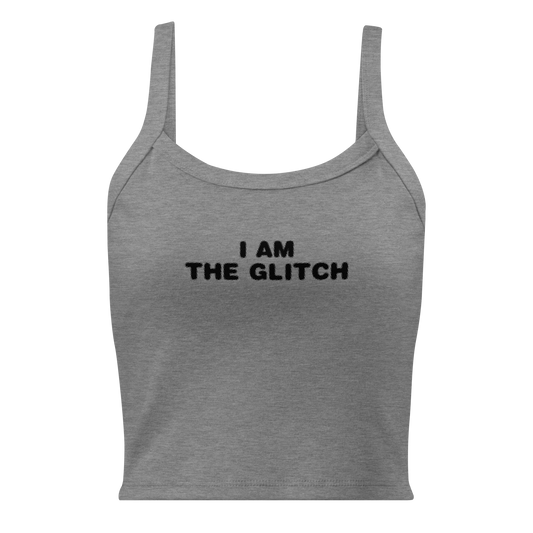 "I am the glitch" printed on a athletic heather women's micro-rib tanktop laying on a flat surface