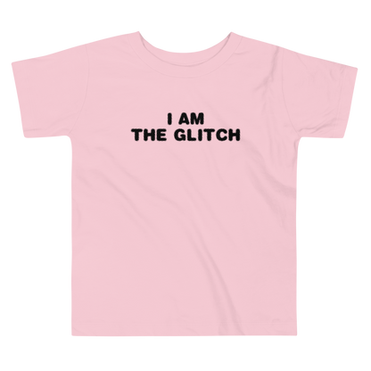 "I am the glitch" printed on a pink toddler short sleeve tee laying on a flat surface