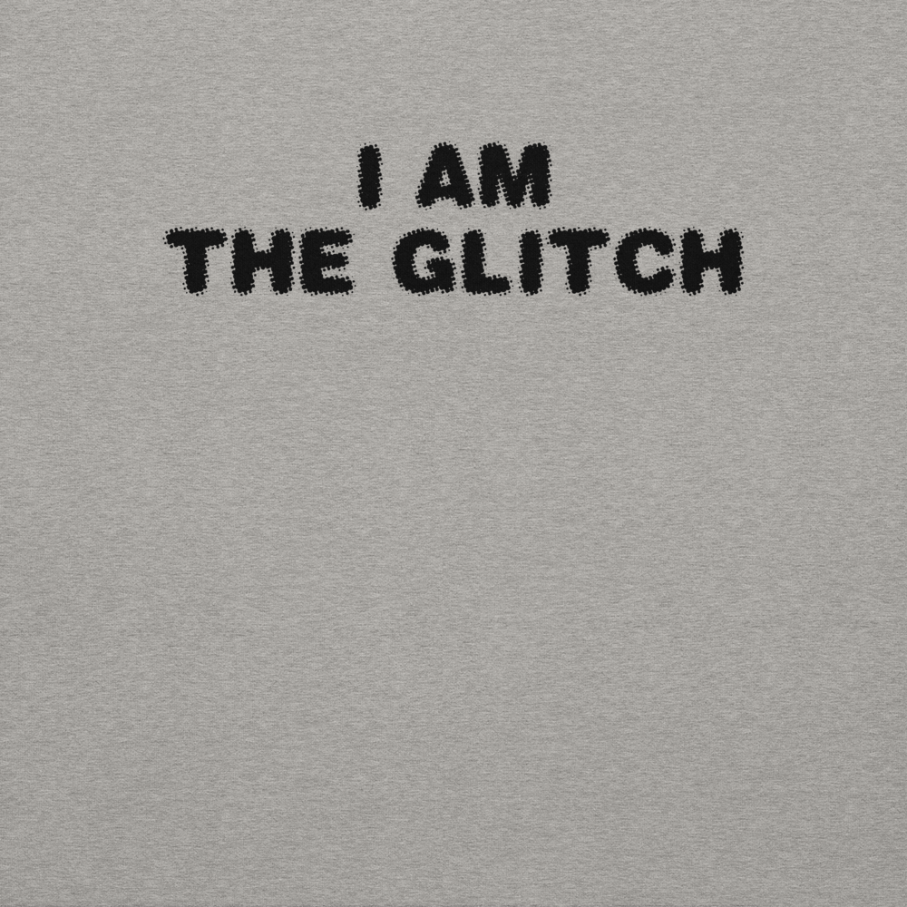 "I am the glitch" printed on a carbon grey background