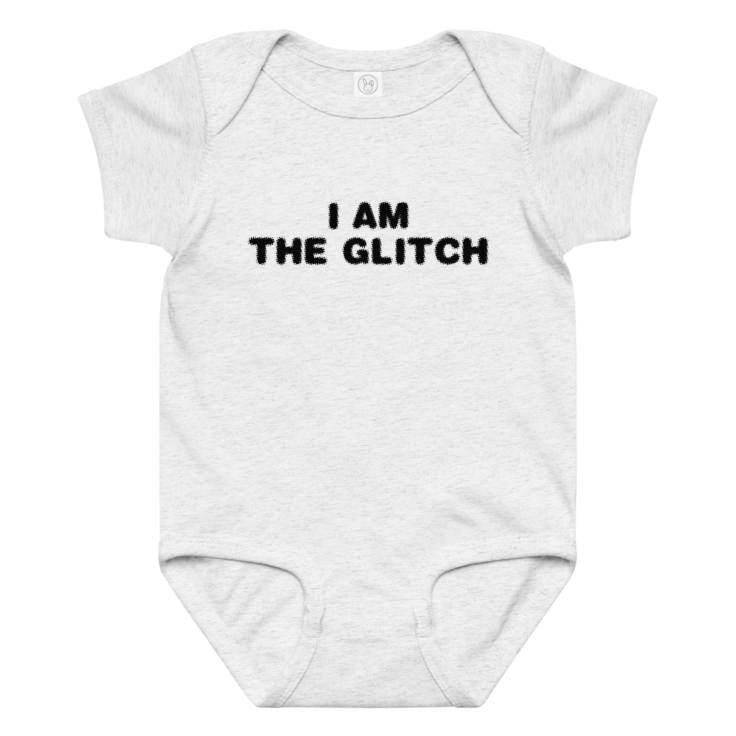 "I am the glitch" printed on a ash baby jersey bodysuit laying on a flat surface amongst other clothes
