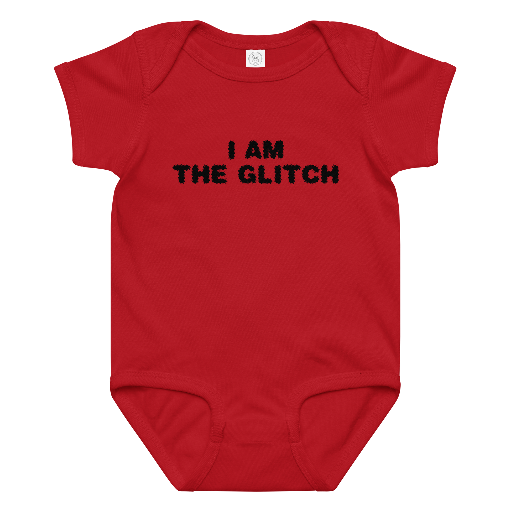 "I am the glitch" printed on a red baby jersey bodysuit laying on a flat surface amongst other clothes