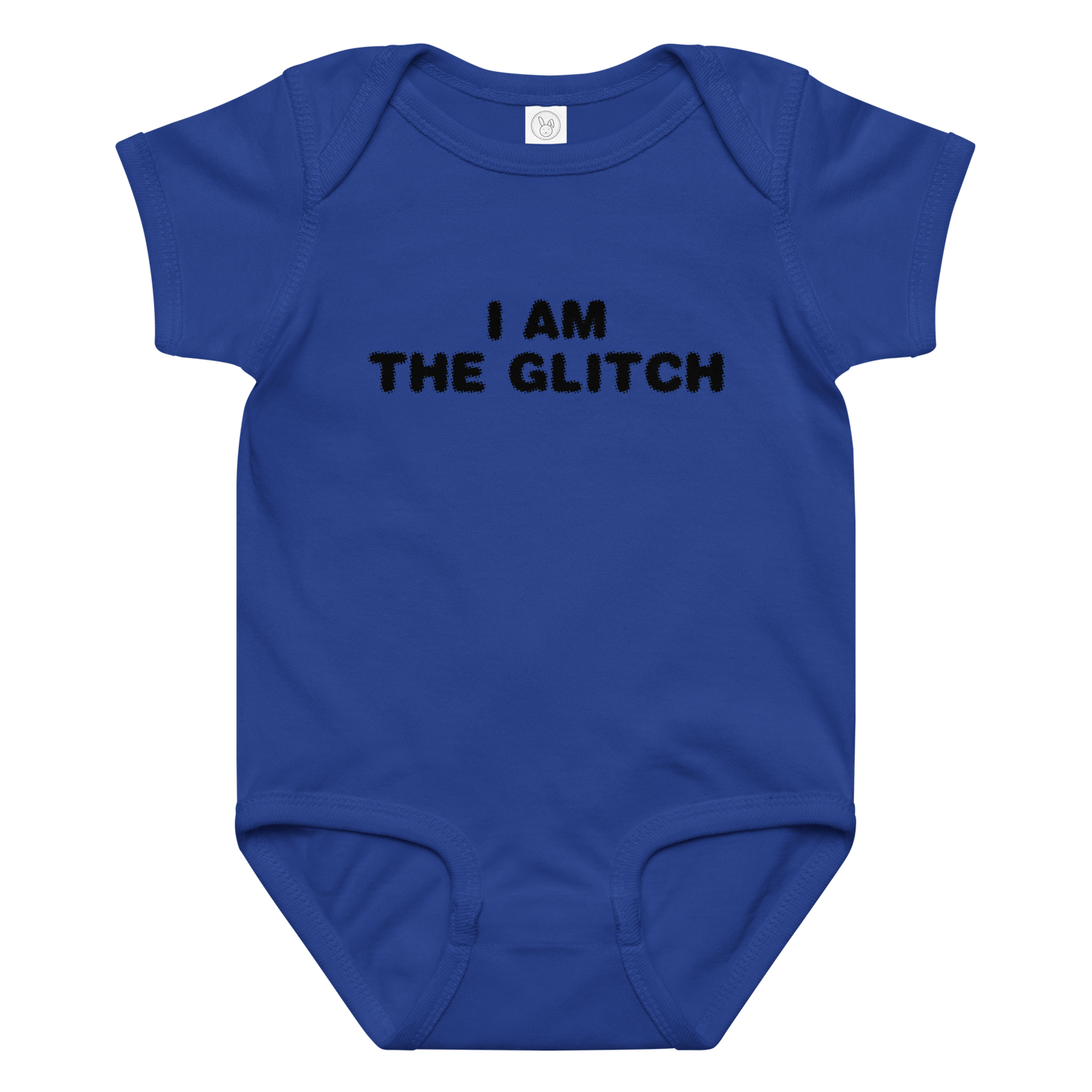 "I am the glitch" printed on a royal baby jersey bodysuit laying on a flat surface amongst other clothes