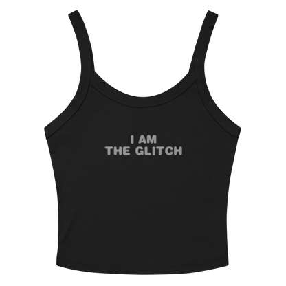 "I am the glitch" printed on a solid black blend women's micro-rib tanktop laying on a flat surface amongst sunglasses and shorts