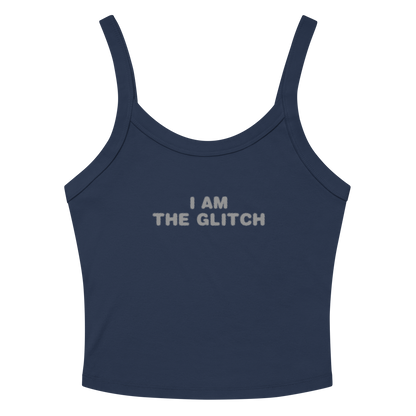 "I am the glitch" printed on a solid navy blend women's micro-rib tanktop laying on a flat surface amongst sunglasses and shorts