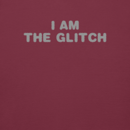 "I am the glitch" printed on a maroon background