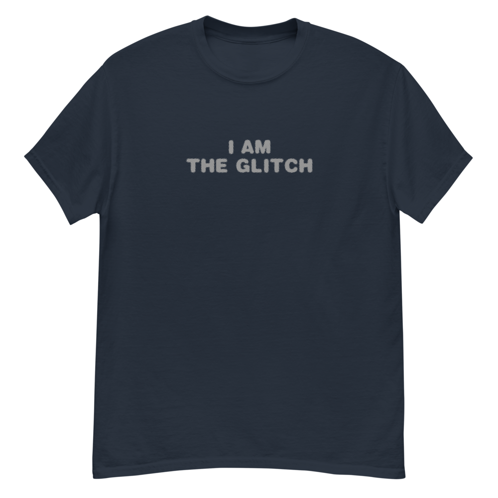 "I am the glitch" printed on a navy unisex classic tee laying on a flat surface