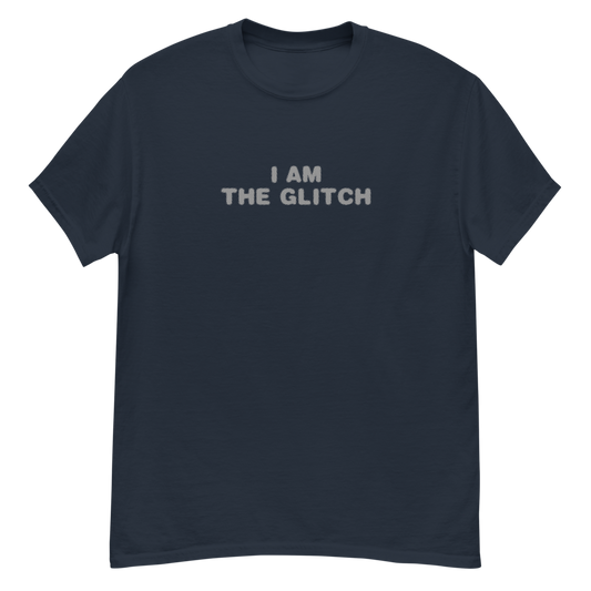 "I am the glitch" printed on a navy unisex classic tee laying on a flat surface