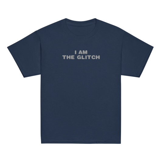 "I am the glitch" printed on a navy youth classic tee laying on a flat surface
