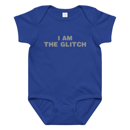 "I am the glitch" printed on a royal baby jersey bodysuit laying on a flat surface amongst other clothes