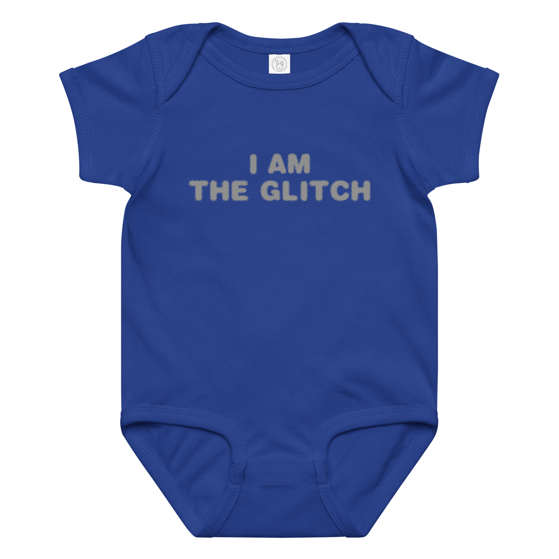 "I am the glitch" printed on a royal baby jersey bodysuit laying on a flat surface amongst other clothes