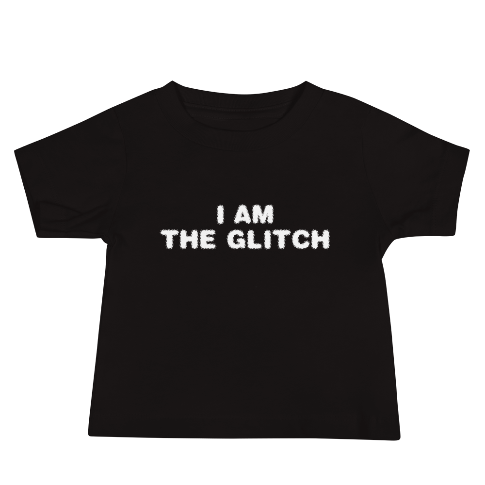 "I am the glitch" printed on a black baby jersey short sleeve tee laying on a flat surface