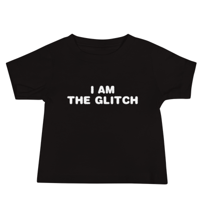 "I am the glitch" printed on a black baby jersey short sleeve tee laying on a flat surface