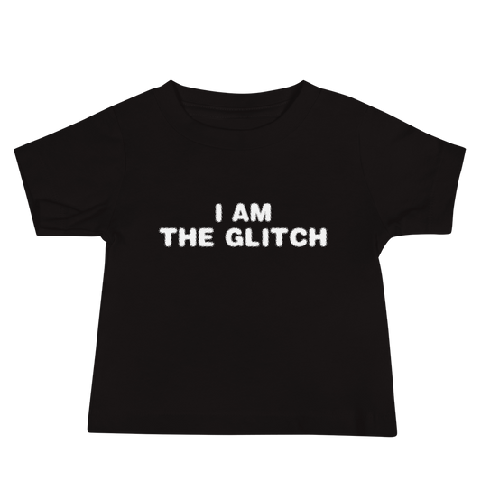 "I am the glitch" printed on a black baby jersey short sleeve tee laying on a flat surface