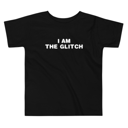 "I am the glitch" printed on a black toddler short sleeve tee laying on a flat surface