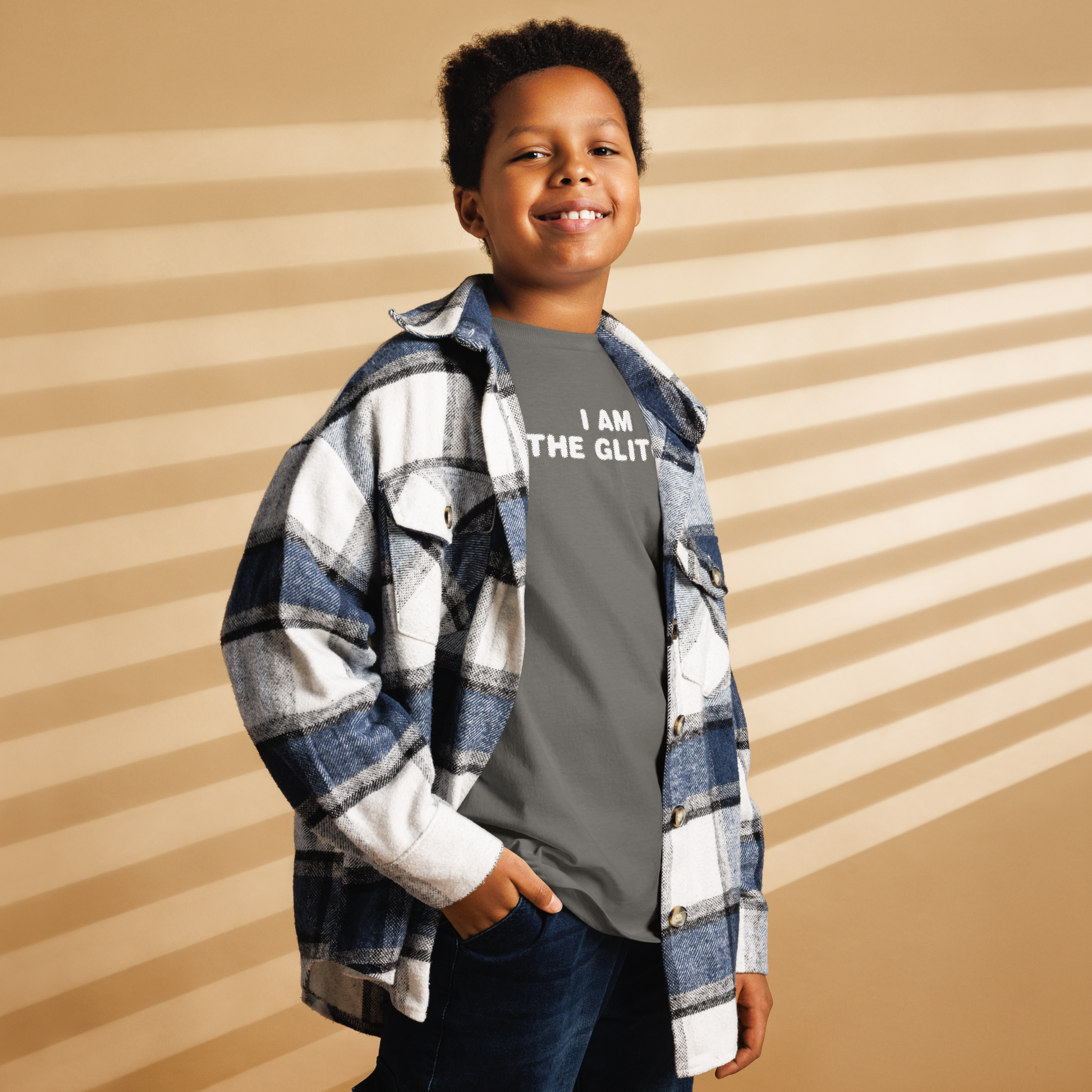 "I am the glitch" printed on a charcoal youth classic tee worn by a male also wearing a jacket