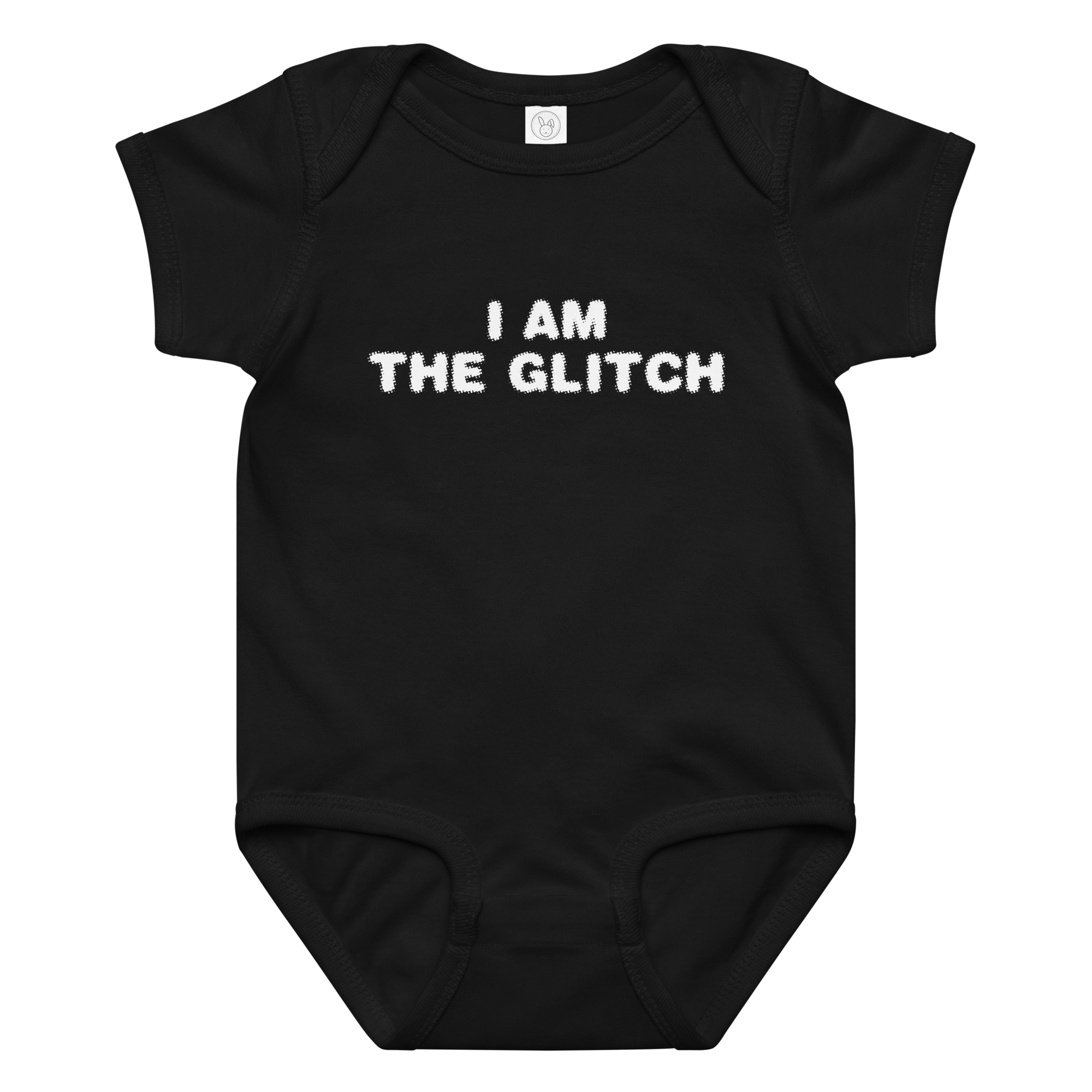 "I am the glitch" printed on a black baby jersey bodysuit laying on a flat surface amongst other clothes