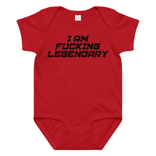 "I Am Fucking Legendary" printed on a red baby jersey bodysuit laying on a flat surface amongst other clothes