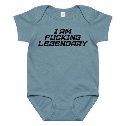 "I Am Fucking Legendary" printed on a vintage indigo baby jersey bodysuit laying on a flat surface amongst other clothes