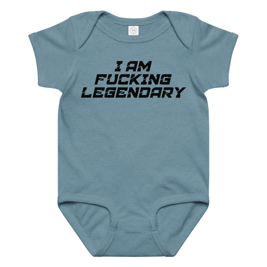 "I Am Fucking Legendary" printed on a vintage indigo baby jersey bodysuit laying on a flat surface amongst other clothes