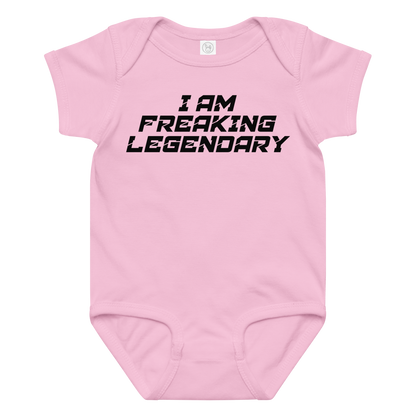 "I Am Freaking Legendary" printed on a pink baby jersey bodysuit laying on a flat surface amongst other clothes