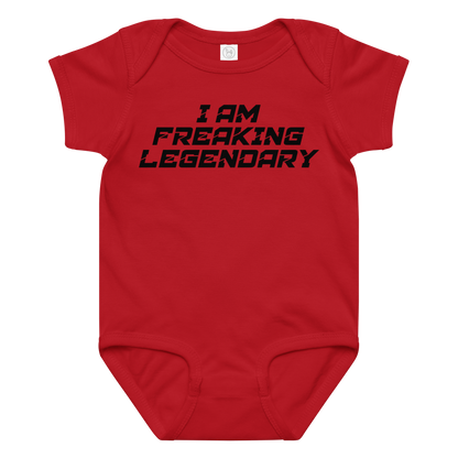 "I Am Freaking Legendary" printed on a red baby jersey bodysuit laying on a flat surface amongst other clothes