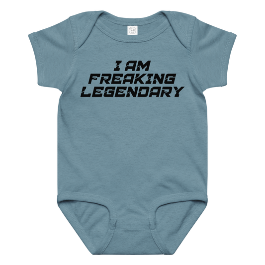 "I Am Freaking Legendary" printed on a vintage indigo baby jersey bodysuit laying on a flat surface amongst other clothes