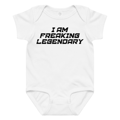 "I Am Freaking Legendary" printed on a white baby jersey bodysuit laying on a flat surface amongst other clothes