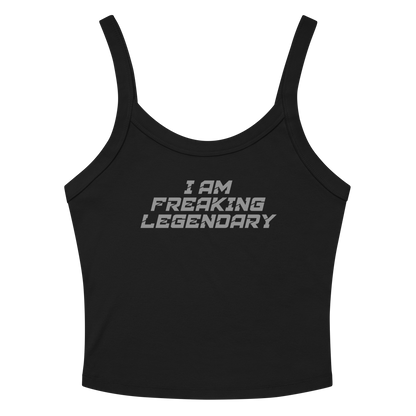 "I Am Freaking Legendary" printed on a solid black blend women's micro-rib tanktop laying on a flat surface amongst sunglasses and shorts