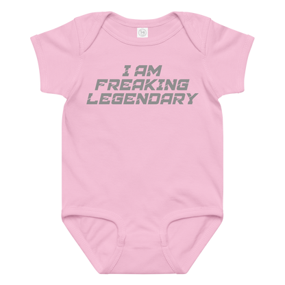 "I Am Freaking Legendary" printed on a pink baby jersey bodysuit laying on a flat surface amongst other clothes