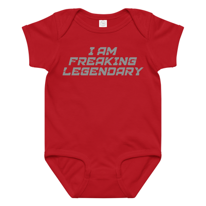 "I Am Freaking Legendary" printed on a red baby jersey bodysuit laying on a flat surface amongst other clothes