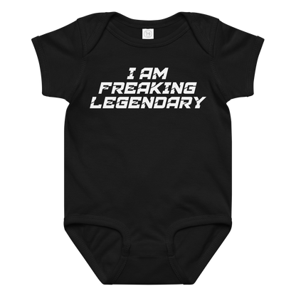 "I Am Freaking Legendary" printed on a black baby jersey bodysuit laying on a flat surface amongst other clothes