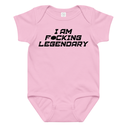 "I Am F*cking Legendary" printed on a pink baby jersey bodysuit laying on a flat surface amongst other clothes