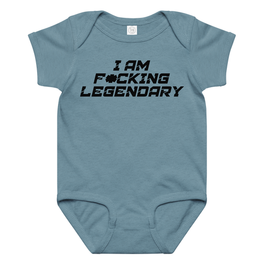 "I Am F*cking Legendary" printed on a vintage indigo baby jersey bodysuit laying on a flat surface amongst other clothes