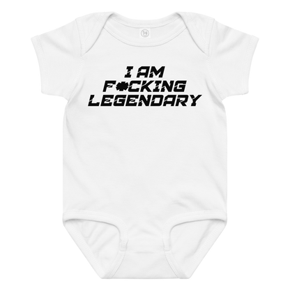"I Am F*cking Legendary" printed on a white baby jersey bodysuit laying on a flat surface amongst other clothes