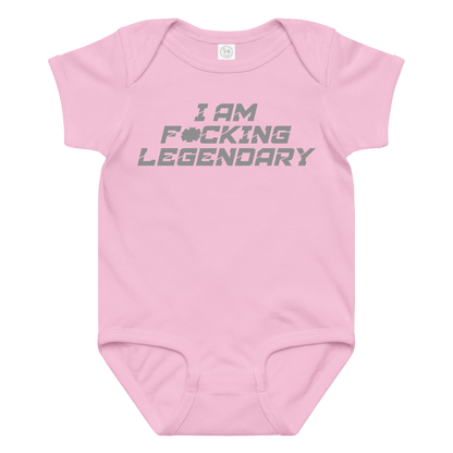 "I Am F*cking Legendary" printed on a pink baby jersey bodysuit laying on a flat surface amongst other clothes