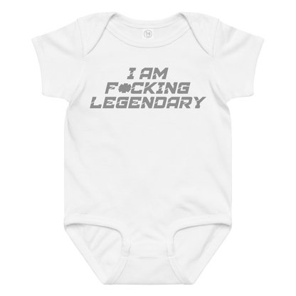 "I Am F*cking Legendary" printed on a white baby jersey bodysuit laying on a flat surface amongst other clothes