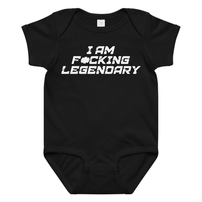 "I Am F*cking Legendary" printed on a black baby jersey bodysuit laying on a flat surface amongst other clothes