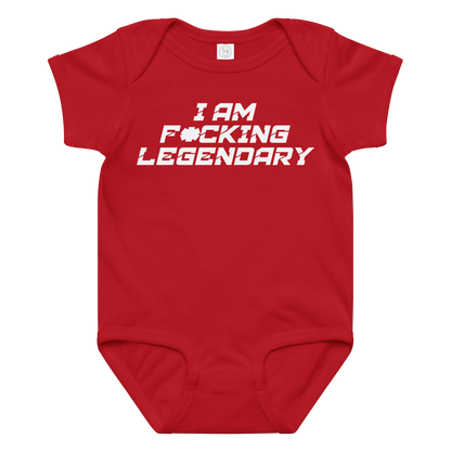 "I Am F*cking Legendary" printed on a red baby jersey bodysuit laying on a flat surface amongst other clothes